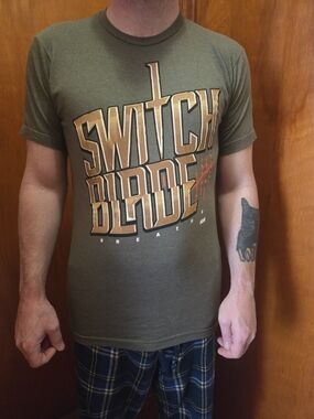 AEW Switchblade Jay White Logo Tee - Olive Green Short Sleeve Men’s Shirt